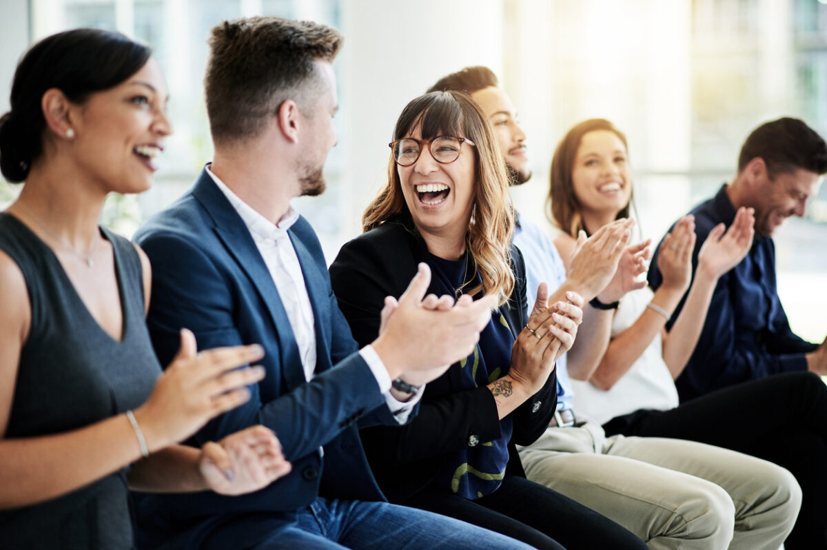 Attendee smiling in the audience at a brand activation event.