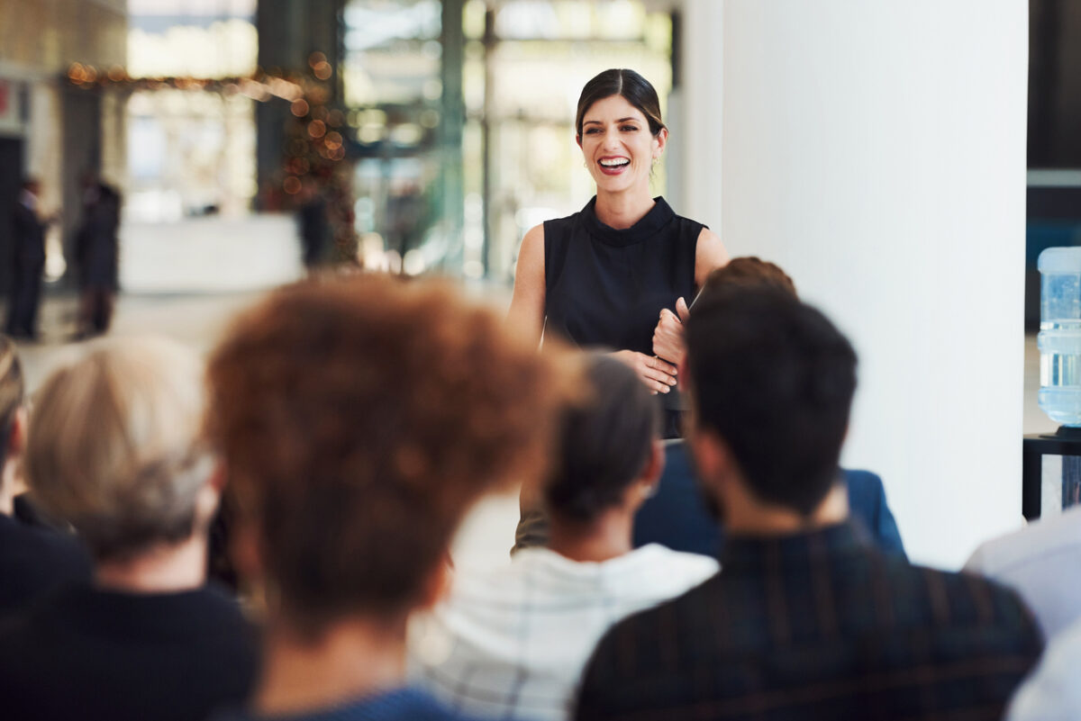 Female executive running a CEO leadership development workshop.