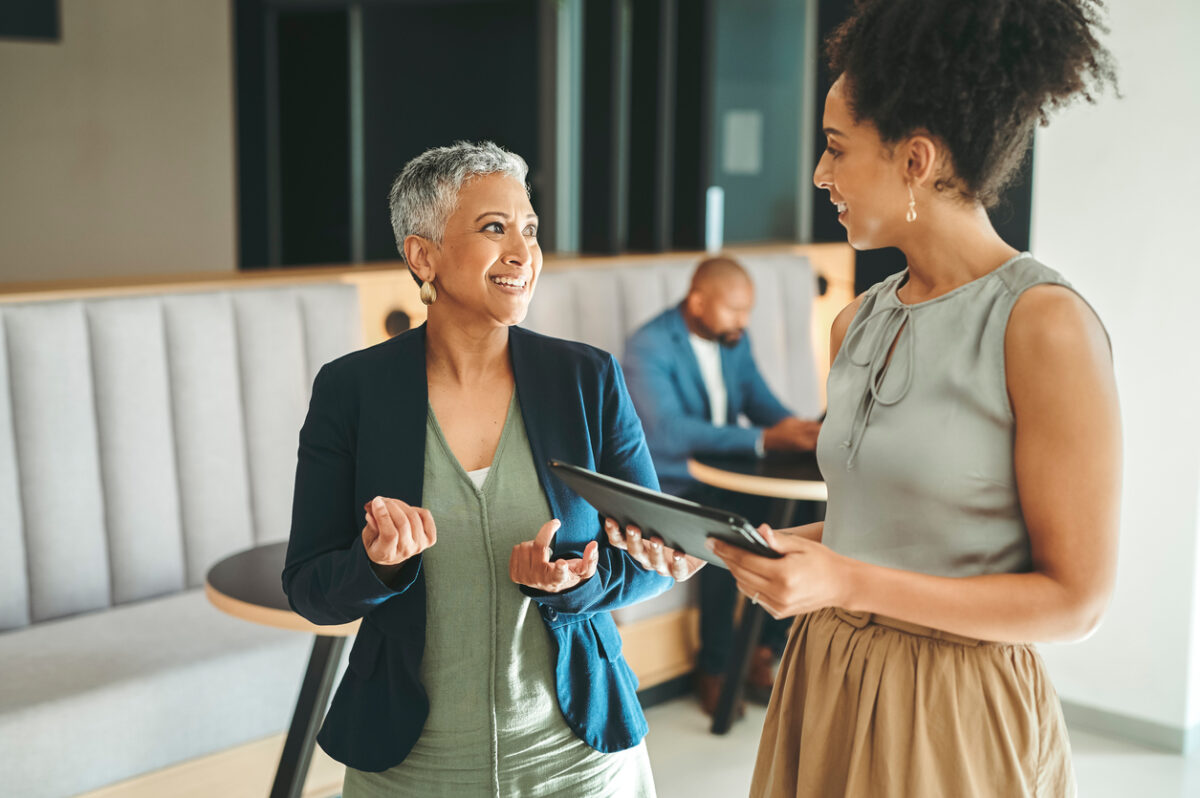 Two female corporate employees having a discussion.